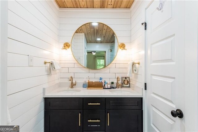 full bathroom featuring decorative backsplash, double vanity, a sink, and wood ceiling