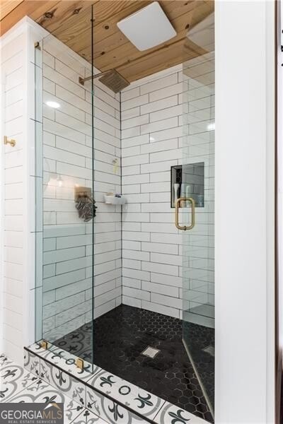 bathroom with an enclosed shower and wooden ceiling