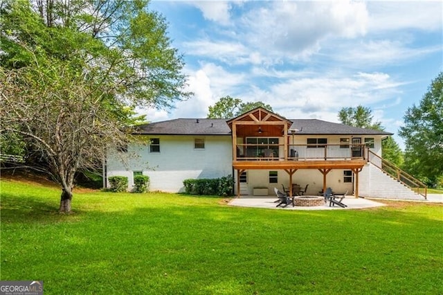 rear view of house featuring a lawn and a patio