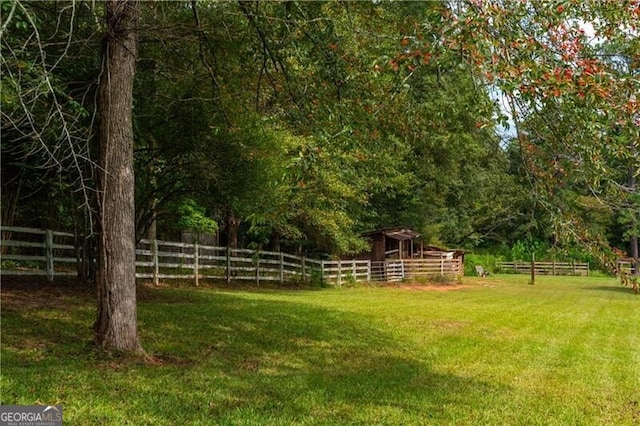 view of yard featuring fence and an outdoor structure