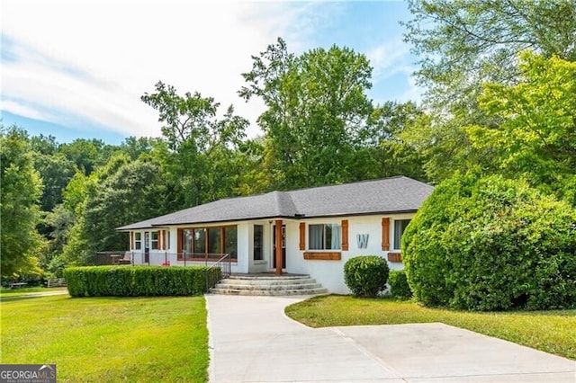 ranch-style house with a porch, a front yard, and stucco siding