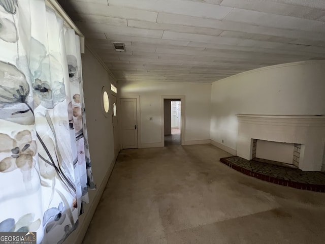 basement with carpet floors and a fireplace