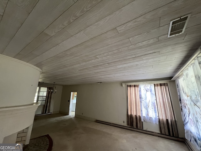 miscellaneous room with wood ceiling, baseboard heating, and concrete floors