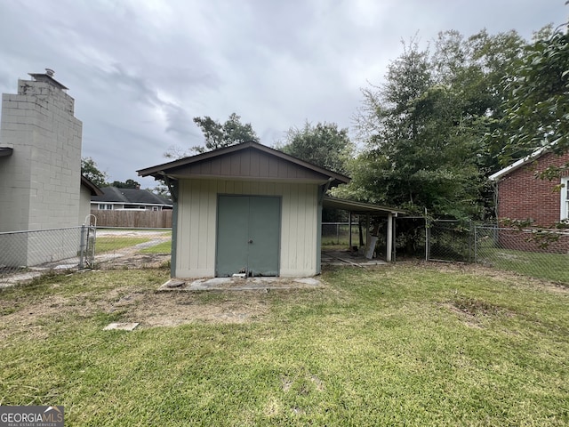 view of outbuilding with a yard