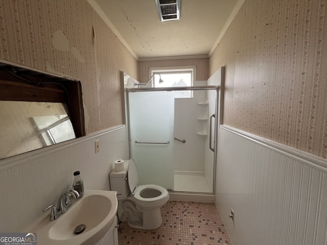 bathroom featuring tile patterned flooring, a shower with door, toilet, sink, and ornamental molding