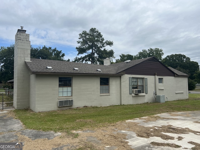 exterior space featuring cooling unit and a yard