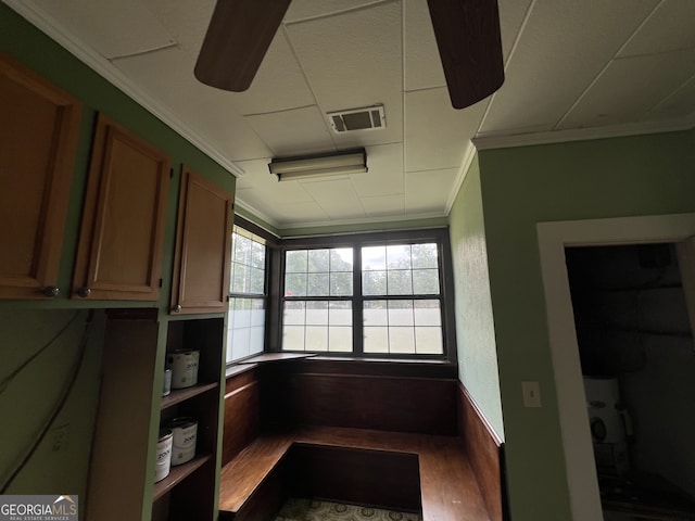 unfurnished office with crown molding and hardwood / wood-style floors