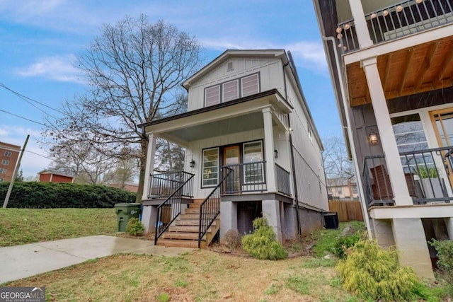 view of front of house with a balcony, a porch, and a front lawn