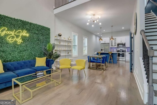 living room featuring a chandelier and light hardwood / wood-style flooring