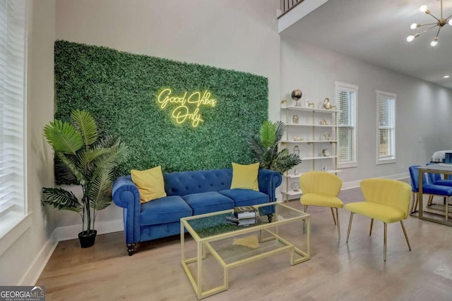 interior space featuring an inviting chandelier, baseboards, and wood finished floors