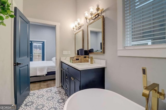 bathroom with a bath, wood-type flooring, and vanity