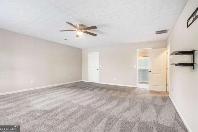 unfurnished bedroom with ceiling fan, carpet, and a textured ceiling