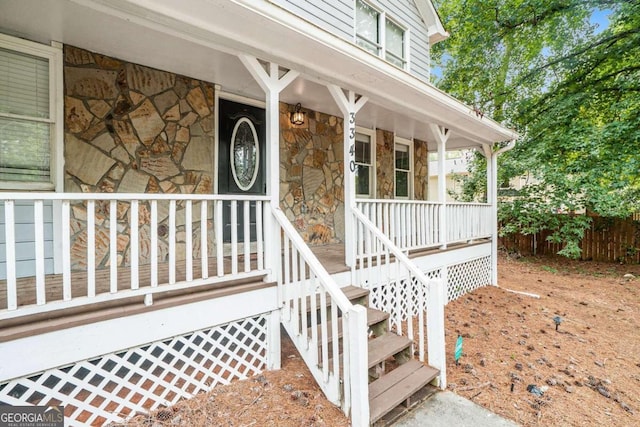 view of exterior entry featuring a porch