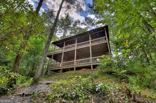 rear view of house with a wooden deck