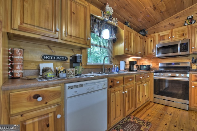 kitchen with light hardwood / wood-style flooring, wood ceiling, stainless steel appliances, sink, and lofted ceiling