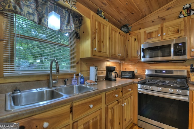 kitchen with lofted ceiling, appliances with stainless steel finishes, wood ceiling, and sink