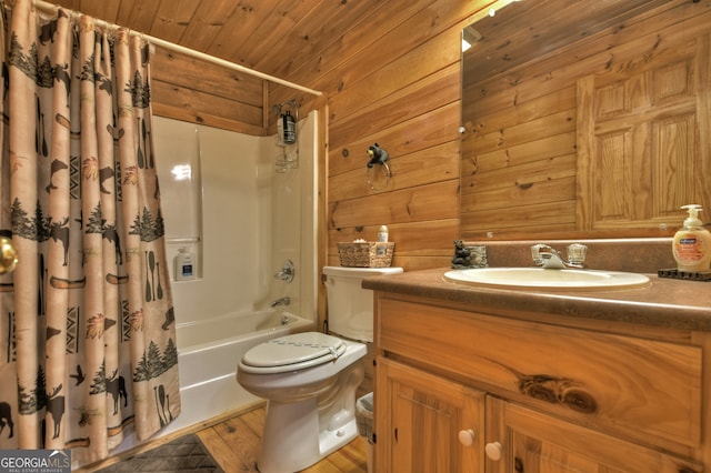 full bathroom featuring vanity, wood-type flooring, toilet, shower / bathtub combination with curtain, and wooden walls