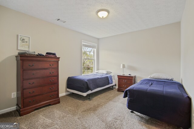 carpeted bedroom with a textured ceiling