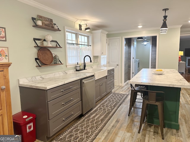 interior space featuring dishwasher, light wood-type flooring, white cabinetry, and crown molding