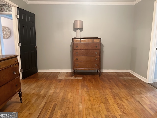 interior space with crown molding and light hardwood / wood-style flooring