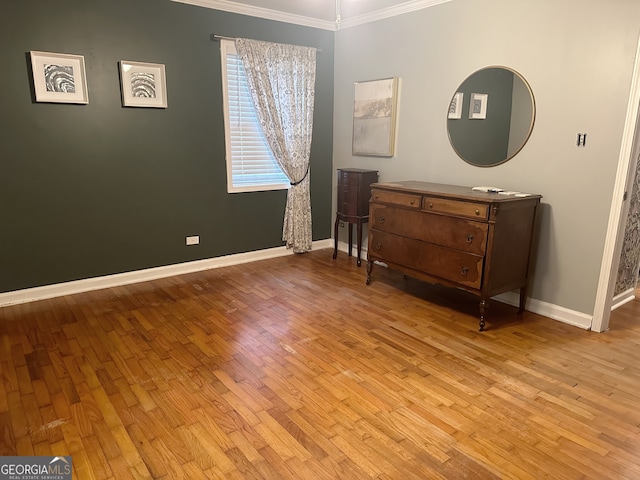 bedroom with light hardwood / wood-style flooring and ornamental molding