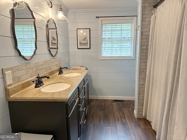 bathroom with vanity, ornamental molding, and hardwood / wood-style floors