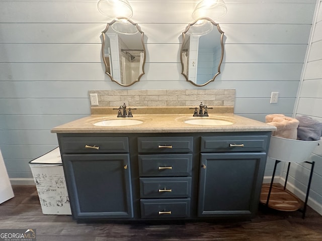 bathroom featuring vanity, wood walls, and hardwood / wood-style floors