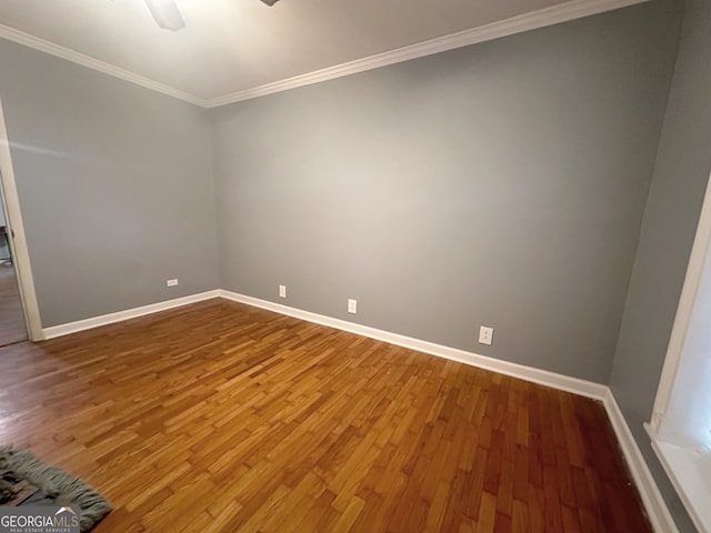 unfurnished room featuring hardwood / wood-style floors, ceiling fan, and crown molding