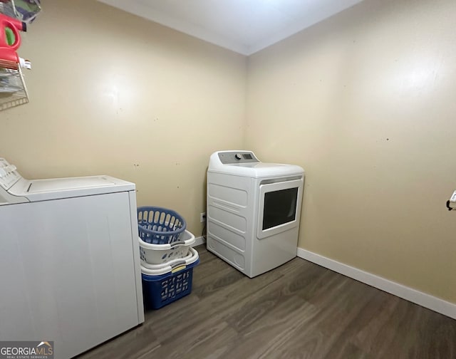 washroom featuring dark wood-type flooring and washer and dryer