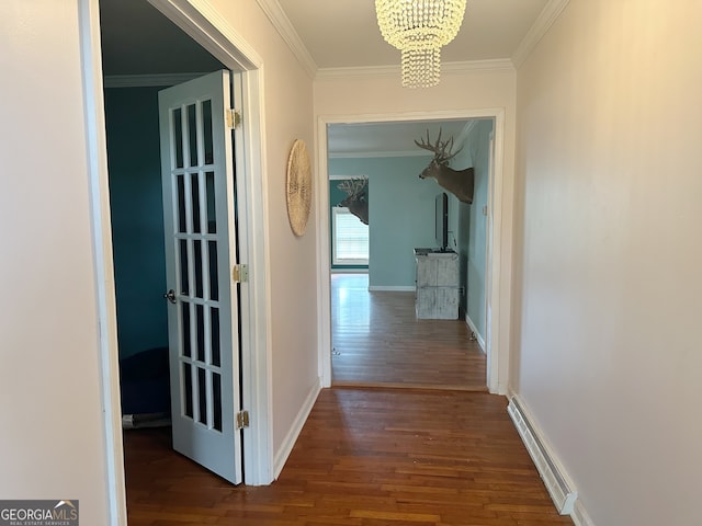 corridor featuring ornamental molding, dark hardwood / wood-style floors, and an inviting chandelier