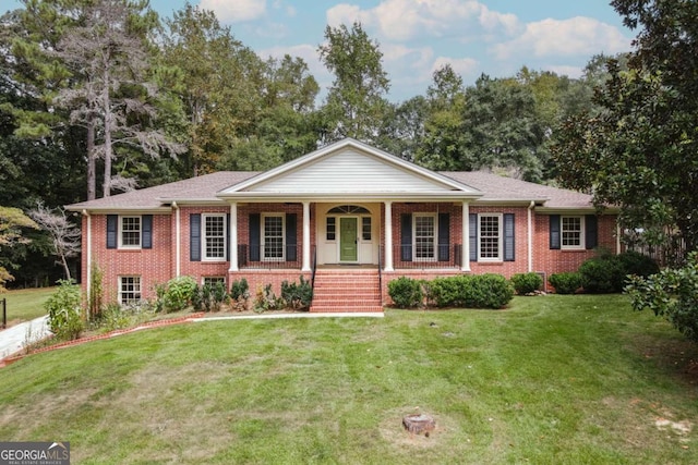 ranch-style home featuring brick siding, a porch, and a front lawn