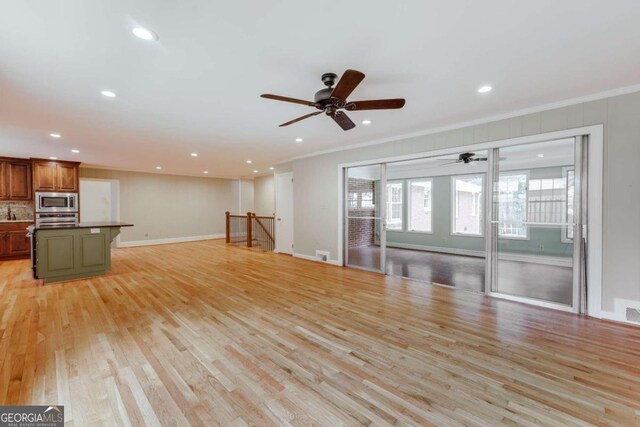 unfurnished living room with ceiling fan, light hardwood / wood-style floors, and crown molding