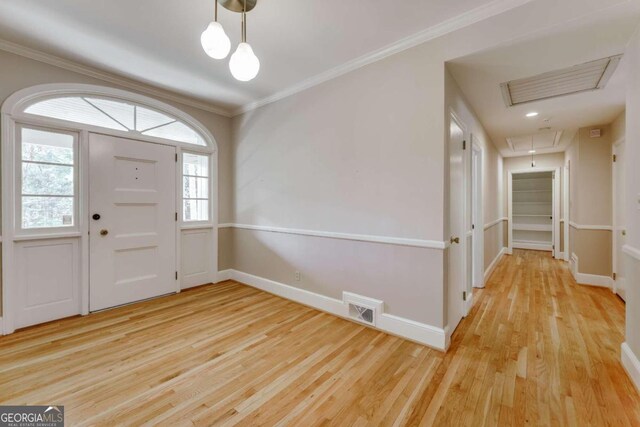 foyer entrance featuring ornamental molding and wood-type flooring