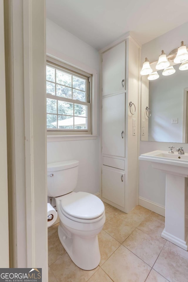 bathroom with toilet and tile patterned floors