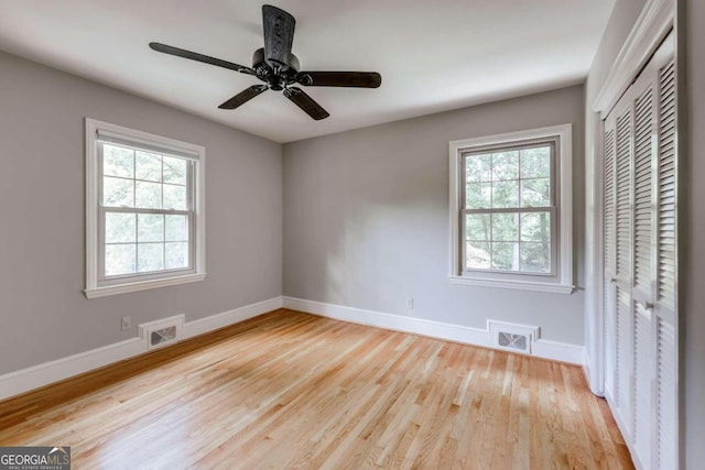 unfurnished bedroom with a closet, ceiling fan, and light hardwood / wood-style flooring