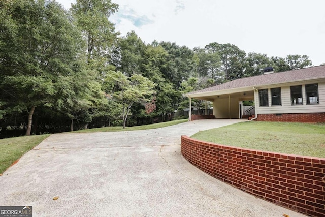 view of patio / terrace with a carport and driveway