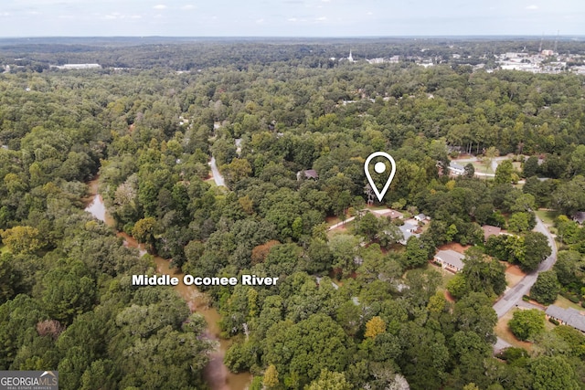 drone / aerial view featuring a forest view