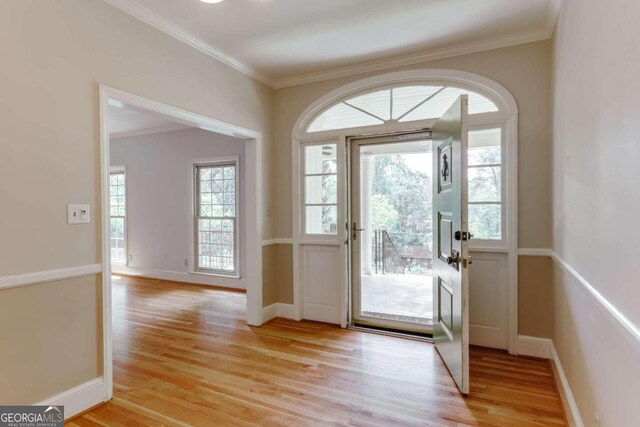 doorway featuring light hardwood / wood-style floors and ornamental molding