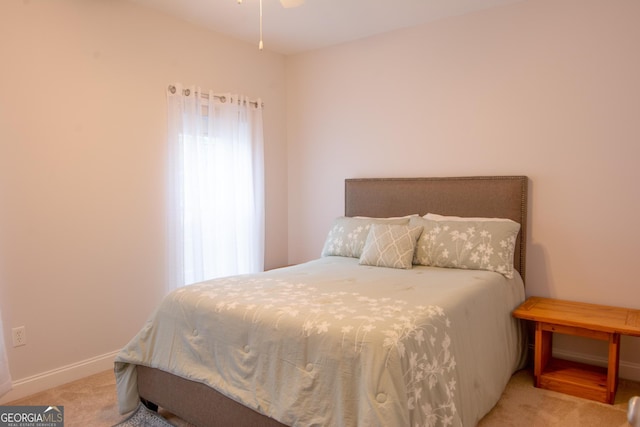 bedroom with baseboards and carpet