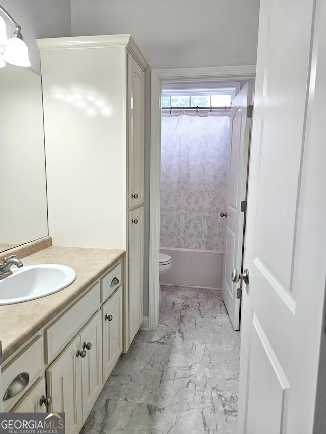 bathroom with vanity, toilet, shower / bath combo with shower curtain, and marble finish floor