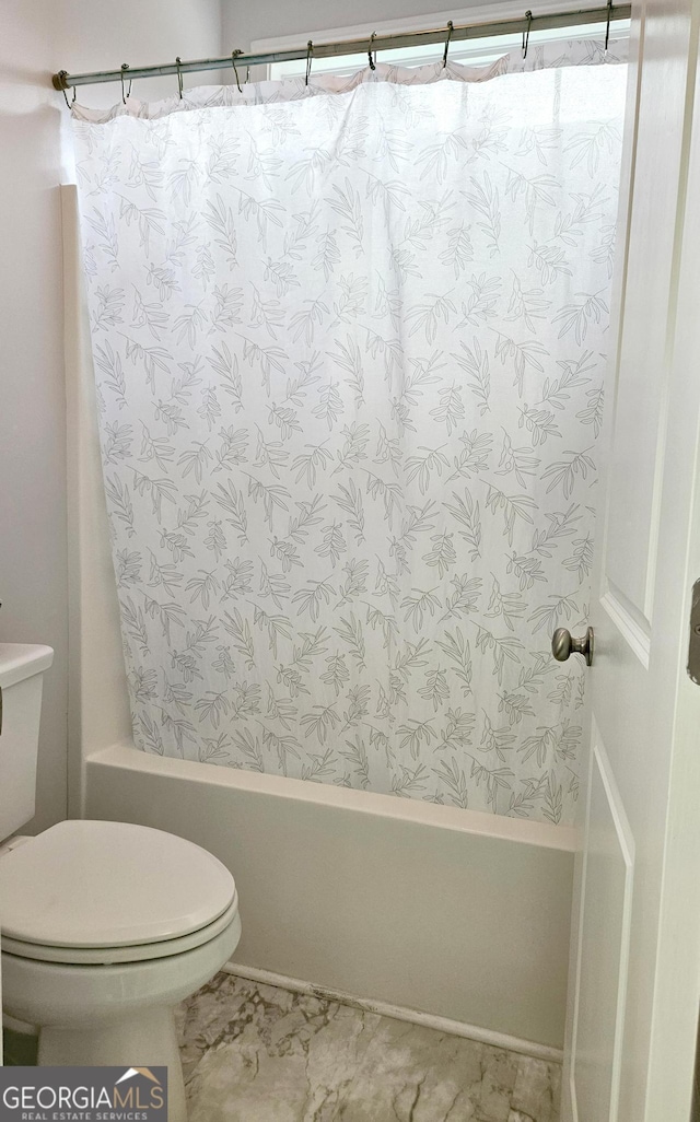 bathroom with shower / bathtub combination with curtain and toilet