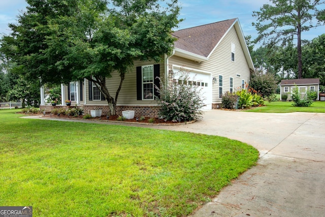 view of front of house with roof with shingles, concrete driveway, and a front lawn