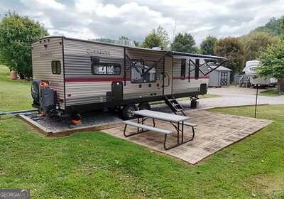 view of property's community with a yard and a patio area