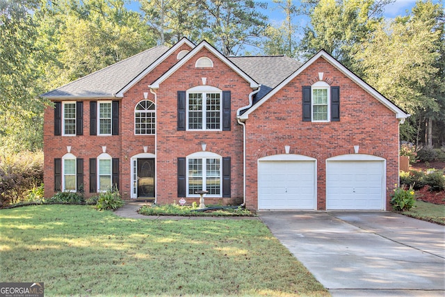 view of front of home with a garage and a front lawn