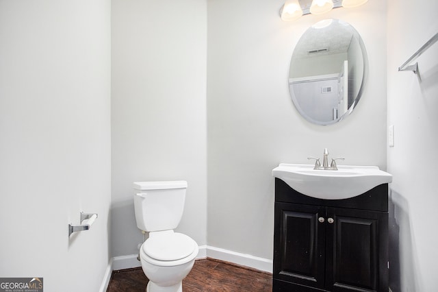 bathroom featuring hardwood / wood-style floors, toilet, and vanity