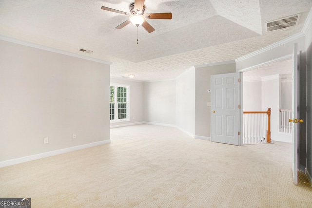 unfurnished room with light carpet, crown molding, ceiling fan, and a textured ceiling