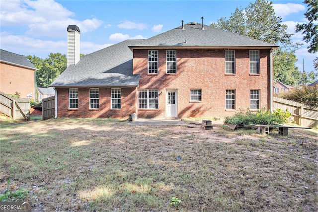 rear view of house with a lawn