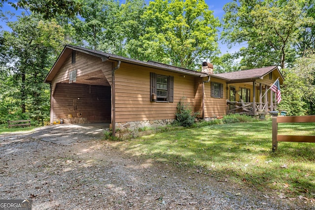 exterior space with a carport and a front lawn