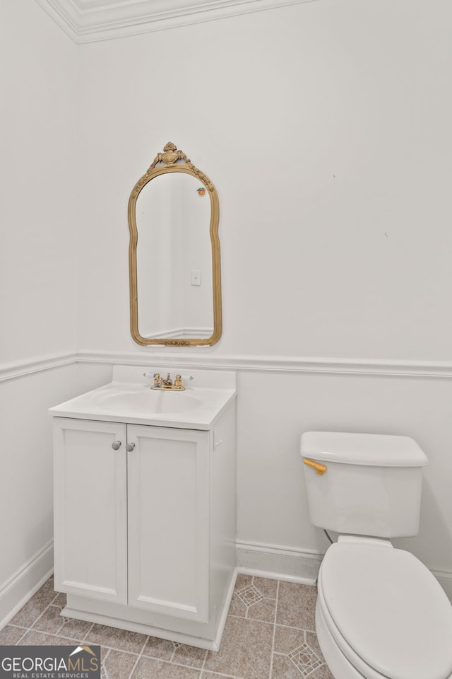 bathroom featuring crown molding, vanity, toilet, and tile patterned floors