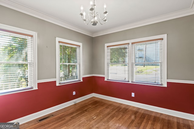 spare room featuring a wealth of natural light and wood-type flooring